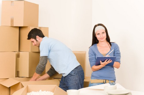 Packed moving boxes and furniture ready for a house move in Eastham