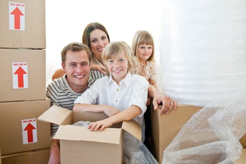 Packed boxes and wrapped furniture ready for transport in East Ham